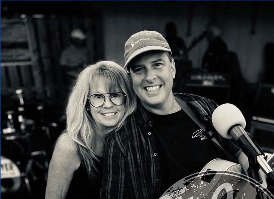 Nowcat's Shelia Bell and Richard D'Anjolell on stage, black and white photo